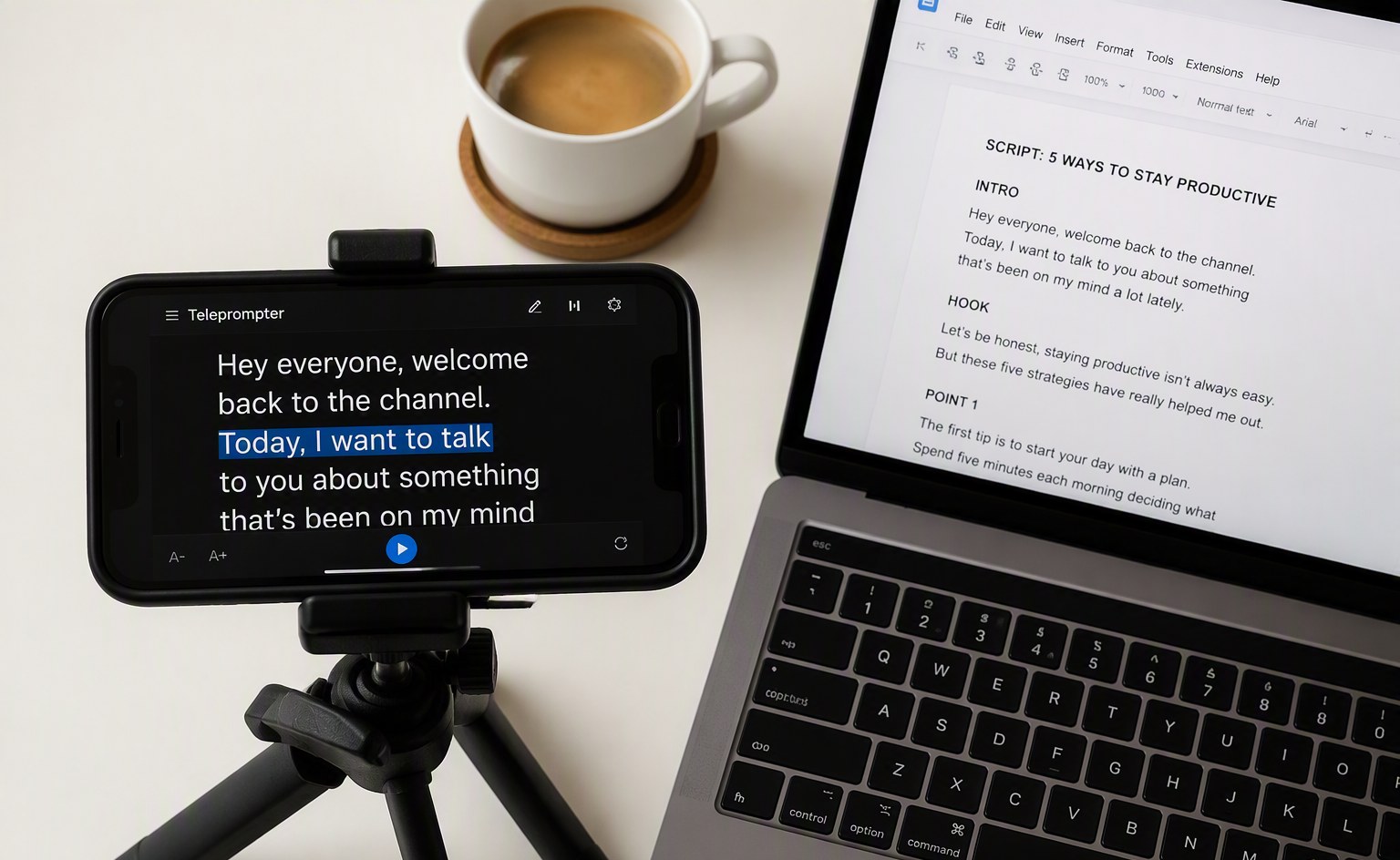 Smartphone on tripod next to laptop with script